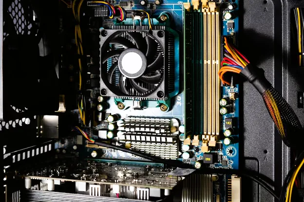 Inside a desktop PC showing the cooling fan, memory slots and motherboard